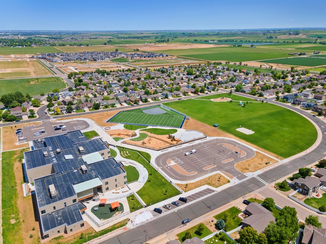 Aerial view of a new suburban development with parks and community amenities in Johnstown, Colorado