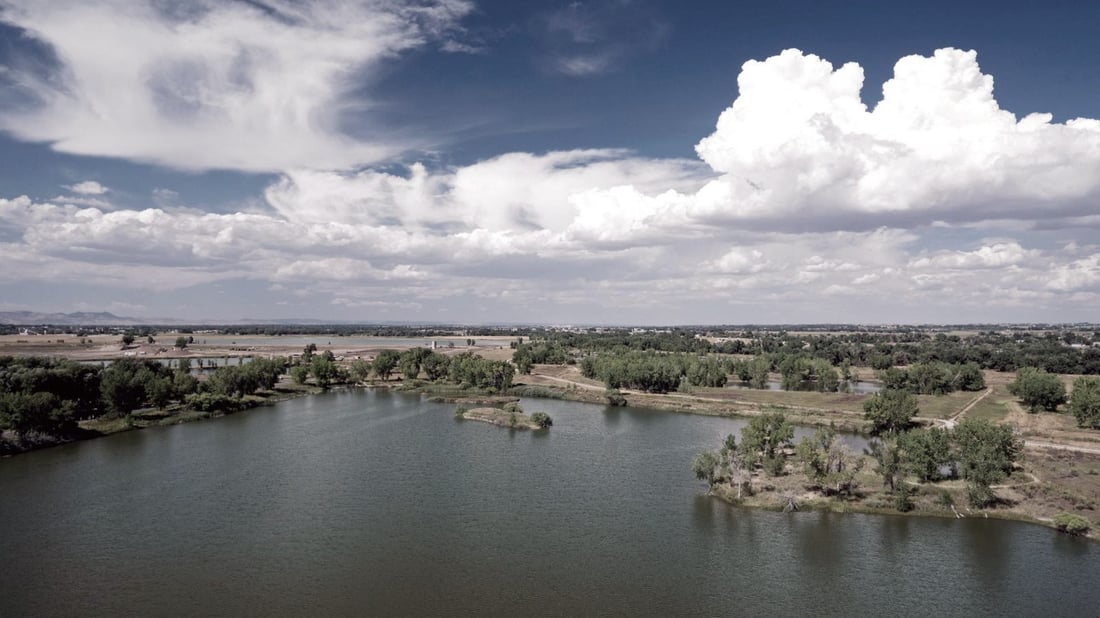 Scenic Northern Colorado landscape with lake and front range foothills
