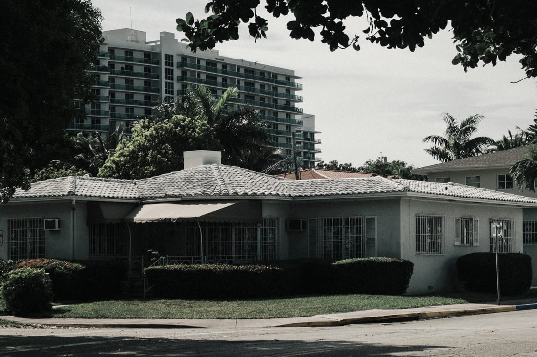 Florida home with tile roof and palm trees
