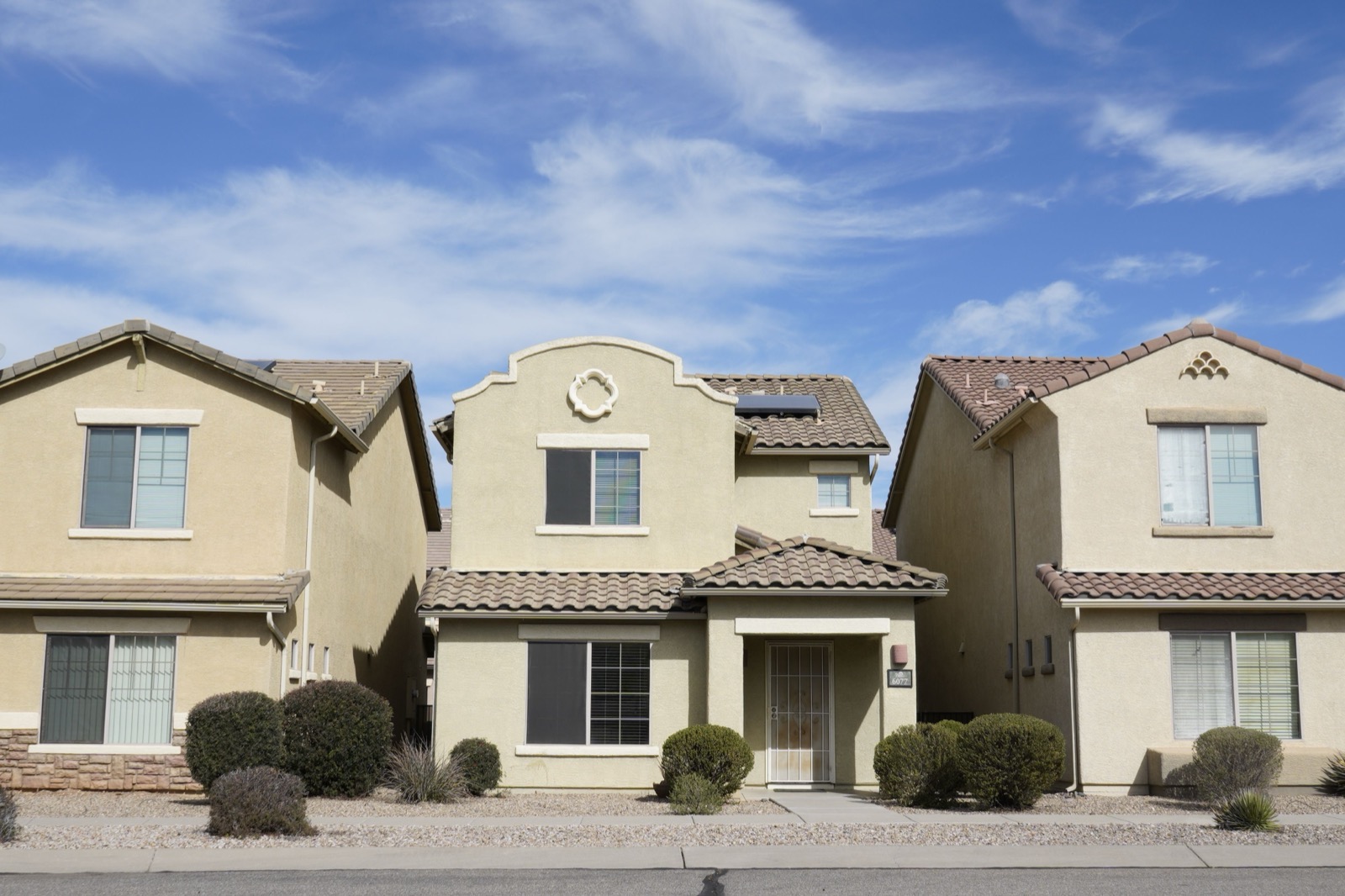 Three southwestern-style houses in a suburban neighborhood of Tucson, Arizona